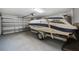 View of spacious garage with garage door and a trailered boat inside at 12215 Adventure Dr, Riverview, FL 33579