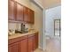 Kitchen area has a coffee bar, cabinets, countertop space, and access to the bathroom and outdoor area at 12215 Adventure Dr, Riverview, FL 33579