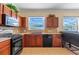 Kitchen area features dark wood cabinets, stainless steel appliances, and eat-in counter area with a view at 12215 Adventure Dr, Riverview, FL 33579