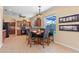 Eat-in kitchen features stainless appliances, dark wood cabinets, and pendant lighting above table at 12215 Adventure Dr, Riverview, FL 33579