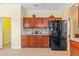 Kitchen includes stainless refrigerator, built in dark wood cabinets, counter space, and tile backsplash at 12215 Adventure Dr, Riverview, FL 33579
