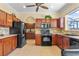 Kitchen with stainless steel appliances, dark wood cabinetry, tile backsplash and sink with window view at 12215 Adventure Dr, Riverview, FL 33579