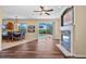Spacious living room features dark hardwood floors, fireplace, ceiling fan, and sliding glass doors to the pool at 12215 Adventure Dr, Riverview, FL 33579