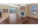 Spacious living room showcasing a fireplace, comfortable seating, and access to the patio at 12215 Adventure Dr, Riverview, FL 33579