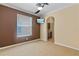 This living room has tile flooring, a ceiling fan, and a television on the wall at 12215 Adventure Dr, Riverview, FL 33579