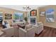 Well-lit living room showcasing a fireplace, comfortable seating, and access to the patio at 12215 Adventure Dr, Riverview, FL 33579