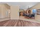 Open concept living room with wood floors leading to kitchen, eat-in area, and staircase in background at 12215 Adventure Dr, Riverview, FL 33579