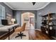Comfortable home office featuring modern desk, hardwood floors, and natural light at 12215 Adventure Dr, Riverview, FL 33579