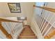 View of the staircase from above with carpeted steps and white railing with wooden trim at 12215 Adventure Dr, Riverview, FL 33579