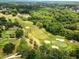Scenic aerial of the golf course at East Lake Woodlands surrounded by lush greenery at 129 Lakeview Way, Oldsmar, FL 34677