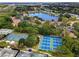 Aerial view of East Lake Woodlands featuring tennis courts, community and lush landscaping at 129 Lakeview Way, Oldsmar, FL 34677