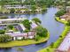 An aerial view overlooking waterfront condo community with lush landscaping and sparkling lake at 129 Lakeview Way, Oldsmar, FL 34677