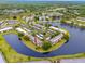 Drone shot of the condominium complex and it's beautiful water views on all sides of the residences at 129 Lakeview Way, Oldsmar, FL 34677