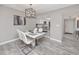 Bright dining area features modern lighting, a stylish white table, and open views to the kitchen at 129 Lakeview Way, Oldsmar, FL 34677