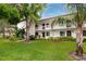 Inviting condo exterior with manicured lawn and tropical landscaping at 129 Lakeview Way, Oldsmar, FL 34677