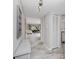 Bright hallway with wood-look tile flooring and storage closet at 129 Lakeview Way, Oldsmar, FL 34677