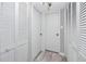 Hallway with white doors with decorative molding, light fixture, and gray flooring at 129 Lakeview Way, Oldsmar, FL 34677