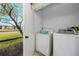 Functional laundry room with modern washer and dryer, offering convenience with a view at 129 Lakeview Way, Oldsmar, FL 34677