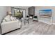 Comfortable living room with gray-tone flooring, a sleek fireplace, and a serene view of the pond at 129 Lakeview Way, Oldsmar, FL 34677