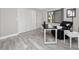 A bright home office with desk, black leather chair, and a view to the outdoors at 129 Lakeview Way, Oldsmar, FL 34677