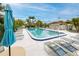 Relaxing community pool with lounge chairs, palm trees, and tropical landscaping, perfect for unwinding and enjoying the sun at 129 Lakeview Way, Oldsmar, FL 34677