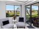 Cozy porch with pond views features comfortable seating, offering a tranquil outdoor retreat at 129 Lakeview Way, Oldsmar, FL 34677