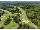 Beautiful aerial view showcasing the golf course alongside lush greenery and a winding river at 129 Lakeview Way, Oldsmar, FL 34677