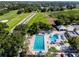 Aerial view of a pool and golf course on a sunny day at 129 Lakeview Way, Oldsmar, FL 34677