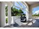 Golf cart parked on a covered patio at Ardea Country Club with decorative railings and columns at 129 Lakeview Way, Oldsmar, FL 34677