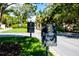 Resident gate with signs, manicured lawns, and lush landscaping leading into the community at 129 Lakeview Way, Oldsmar, FL 34677