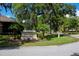 Town Center sign at East Lake Woodlands Country Club amid manicured landscaping and mature trees at 129 Lakeview Way, Oldsmar, FL 34677
