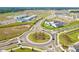 An aerial view of a new community and amenities, including a school and roundabout at 13102 Foxtail Fern Dr, Riverview, FL 33579