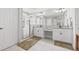 Well-lit bathroom featuring double sinks, granite countertops, and a walk-in shower with elegant tile work at 13102 Foxtail Fern Dr, Riverview, FL 33579