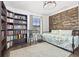Charming bedroom with a wooden accent wall, daybed, large bookshelf, and natural light at 13102 Foxtail Fern Dr, Riverview, FL 33579