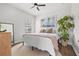 Bright bedroom featuring neutral decor, ceiling fan and large picture window providing plenty of natural light at 13102 Foxtail Fern Dr, Riverview, FL 33579