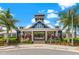 Beautiful clubhouse with lush landscaping, covered entry and neighborhood signage at 13102 Foxtail Fern Dr, Riverview, FL 33579