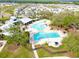 Aerial view highlighting the community pool, clubhouse, and recreational facilities in the neighborhood at 13102 Foxtail Fern Dr, Riverview, FL 33579