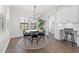 Dining room features a table with seating for six and a breakfast bar in a well-lit room at 13102 Foxtail Fern Dr, Riverview, FL 33579