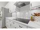 Bright kitchen features white cabinetry, stainless appliances, quartz countertops, and tile backsplash at 13102 Foxtail Fern Dr, Riverview, FL 33579