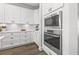 Modern kitchen features white cabinets, stainless appliances including built-in oven and microwave at 13102 Foxtail Fern Dr, Riverview, FL 33579