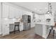 Spacious kitchen with modern stainless steel appliances, white cabinetry, and an island with seating at 13102 Foxtail Fern Dr, Riverview, FL 33579