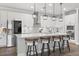 Gourmet kitchen with stainless steel appliances, white cabinets, and a large central island at 13102 Foxtail Fern Dr, Riverview, FL 33579