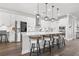 Modern kitchen features an island with seating, stainless appliances, quartz counters, and pendant lighting at 13102 Foxtail Fern Dr, Riverview, FL 33579