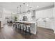 Spacious kitchen features island with seating, stainless appliances, quartz counters, and pendant lighting at 13102 Foxtail Fern Dr, Riverview, FL 33579