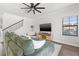 Open-concept living room with plush seating, stairs, and an adjacent dining area at 13102 Foxtail Fern Dr, Riverview, FL 33579
