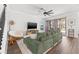 Cozy living room with a large sofa and access to the outdoor patio at 13102 Foxtail Fern Dr, Riverview, FL 33579