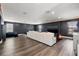 Spacious entertainment room boasts recessed lighting, dark walls, and ample seating for a relaxing night in at 13102 Foxtail Fern Dr, Riverview, FL 33579