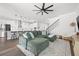 Open-concept living room with a large sofa and view of the kitchen at 13102 Foxtail Fern Dr, Riverview, FL 33579