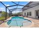 Backyard pool area featuring lounge seating and a screened enclosure for outdoor enjoyment at 13102 Foxtail Fern Dr, Riverview, FL 33579