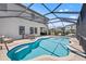Backyard with a large screened in pool and lots of patio furniture at 13102 Foxtail Fern Dr, Riverview, FL 33579